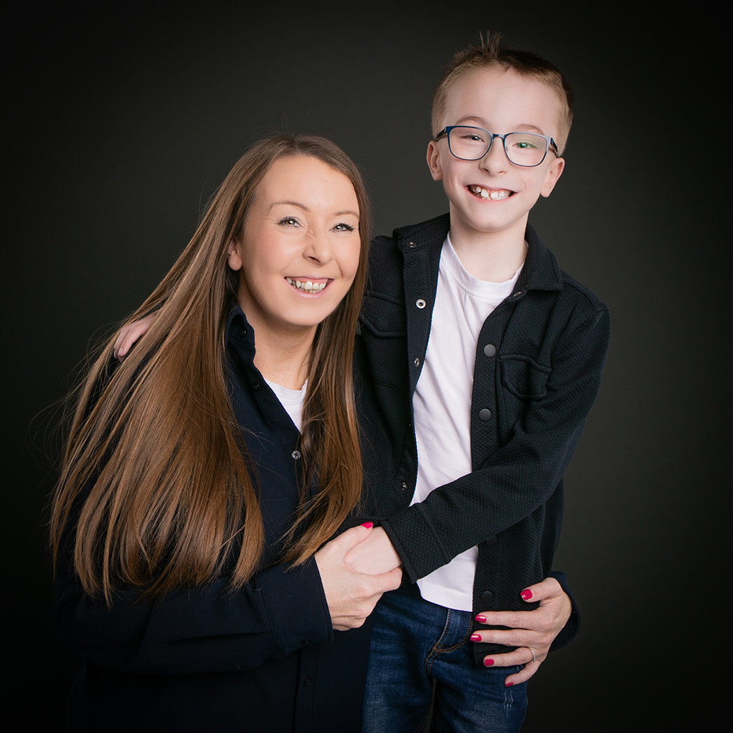 Rachael and her son Theo smiling together in a studio portrait