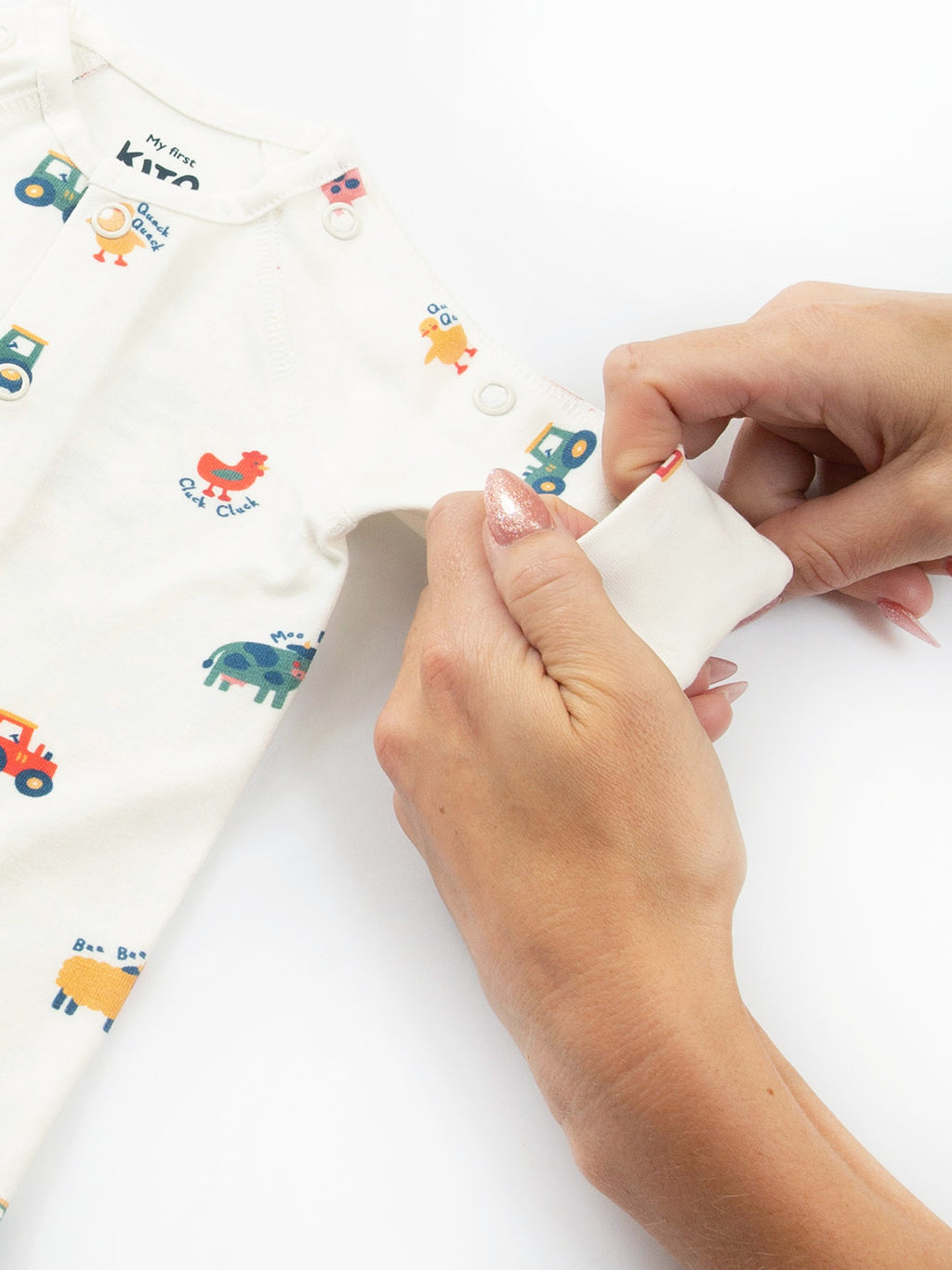 Close-up sleeve cuff detail on preemie organic cotton sleepsuit Old MacDonald