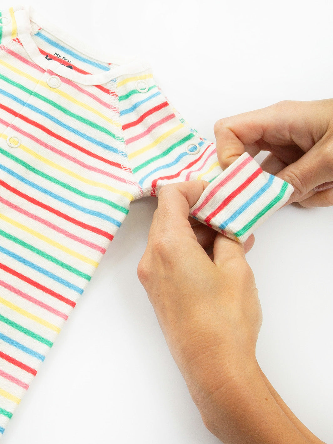 Close-up sleeve cuff detail on preemie organic cotton sleepsuit Rainbow Stripe